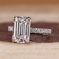 Four claw prong setting emerald cut diamond ring.