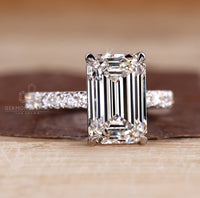 Handmade ring with emerald cut diamond and pave design.