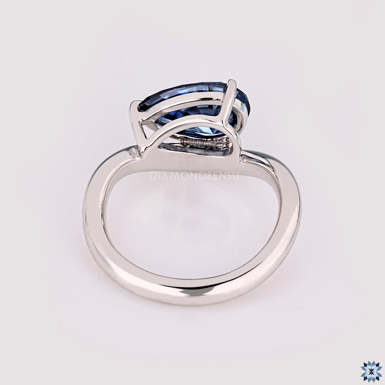Elegant pear cut moissanite ring with gypsy band.