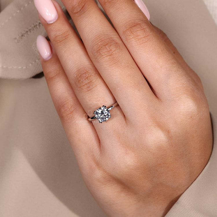 Round brilliant diamond ring with classic solitaire design.

