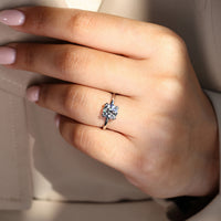 Simple white gold engagement ring with brilliant round diamond.
