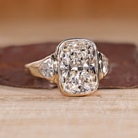 Cushion Cut Diamond Ring with two trillion stones.
