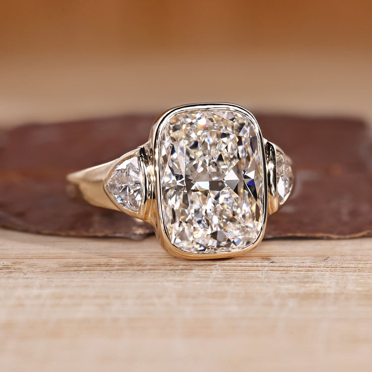 Cushion Cut Diamond Ring with two trillion stones.
