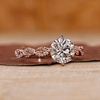 Nature inspired engagement ring with prong set round diamond.
