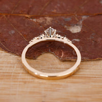 Round cut side stone with oval diamond engagement ring.
