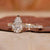 Elegant hidden halo setting with pear-shaped diamond