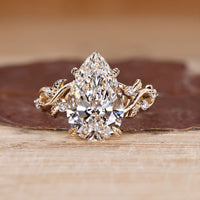Pear Cut Diamond Ring with round side stones.
