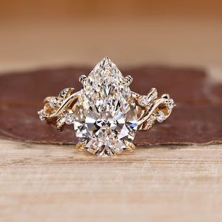 Pear Cut Diamond Ring with round side stones.
