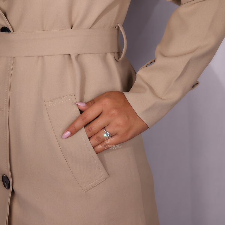 But engagement ring designed with a round centre and twisted band.
