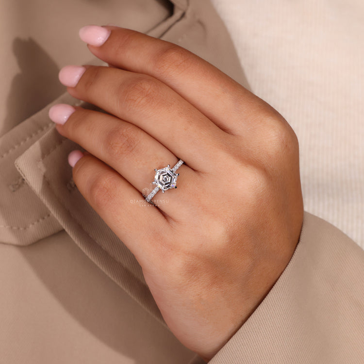 Six claw prong setting ring with hexagon diamond in white gold.
