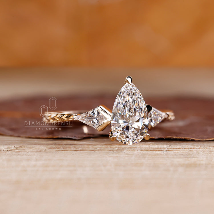 Lab grown pear diamond ring kite three stone style.