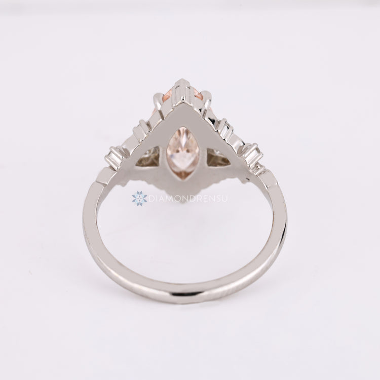 Lab grown pink marquise diamond ring with side stones.