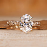 Oval cut ring with round diamond bridge accents.