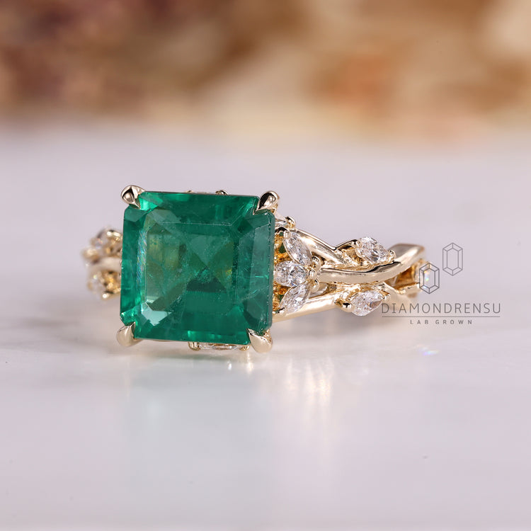 Asscher emerald ring twisted shank four claw prong set.
