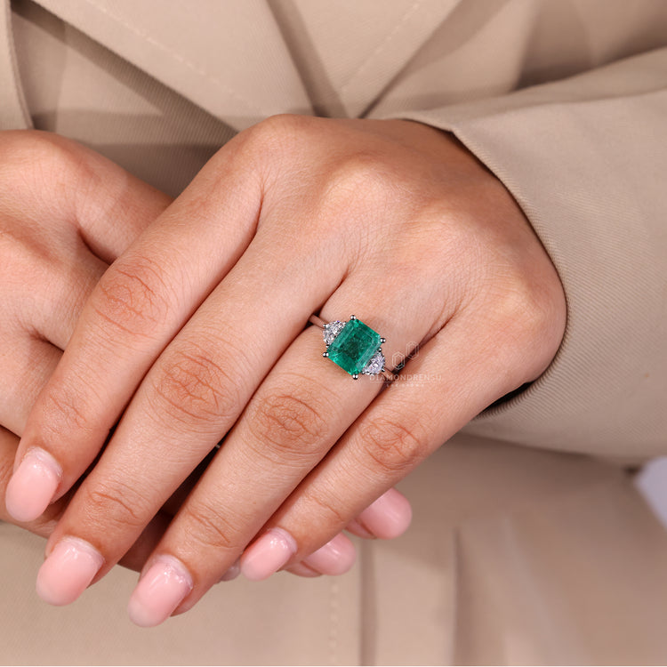 Emerald cut emerald ring cathedral tapered shank set.
