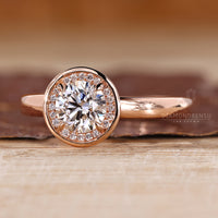 Lab grown round diamond ring halo bezel style.
