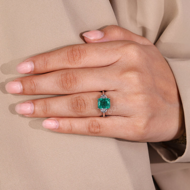Emerald gemstone ring prong setting tapered shank style.
