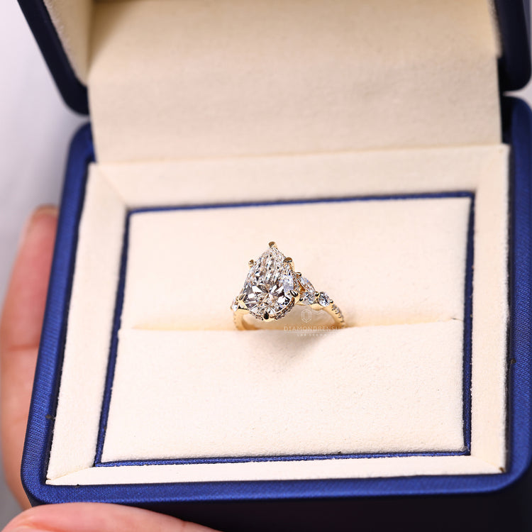 Lab grown pear diamond ring in cathedral setting.
