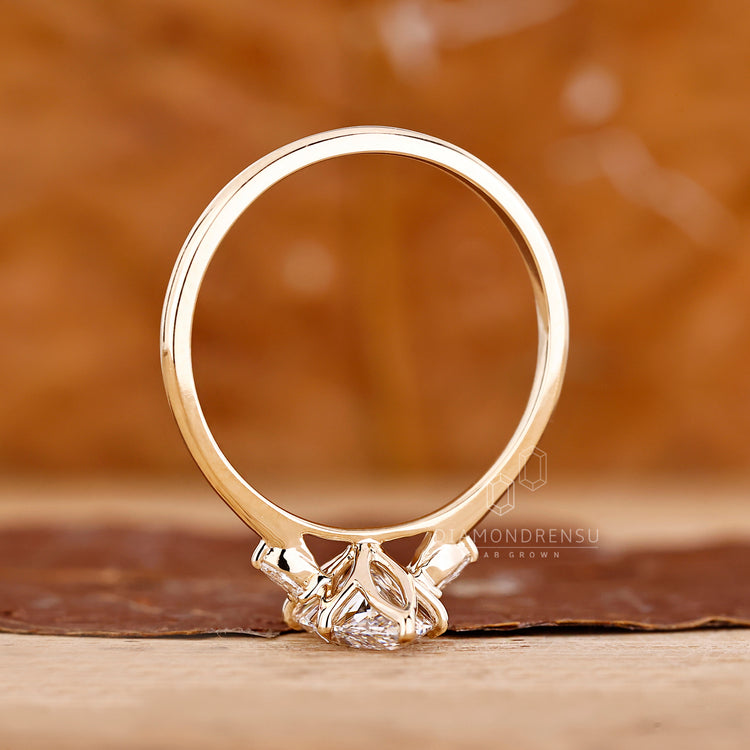 Marquise ring pear stones six claw prong setting.
