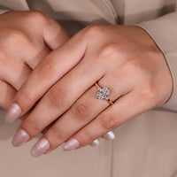 Oval cut ring round stones six claw prong setting.

