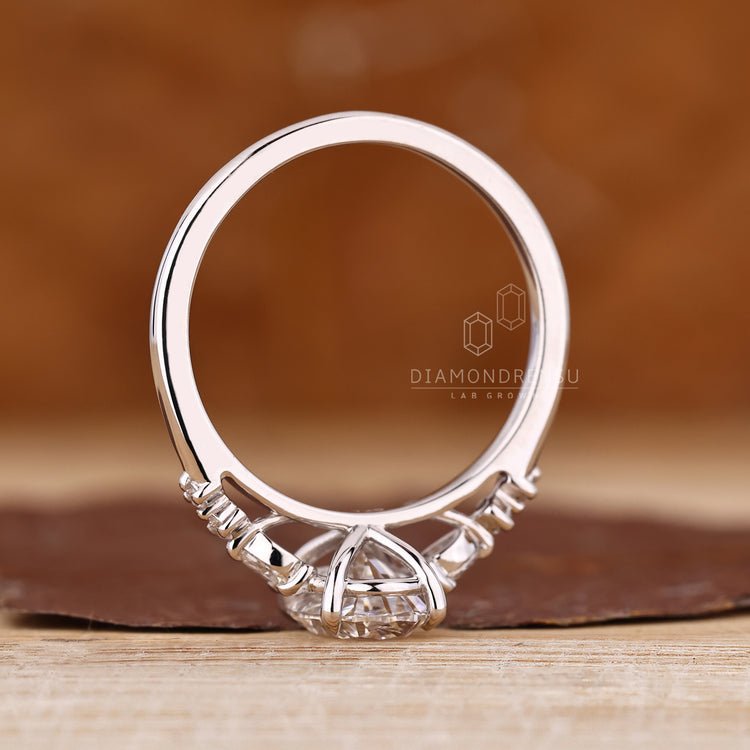 Oval diamond ring cathedral seven stone design.
