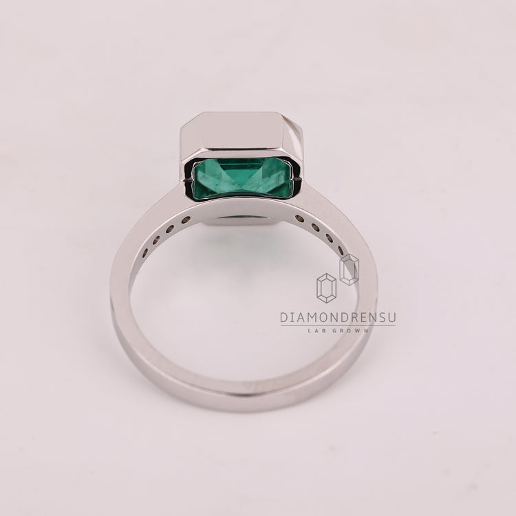 Asscher cut ring bezel emerald round diamond channel.
