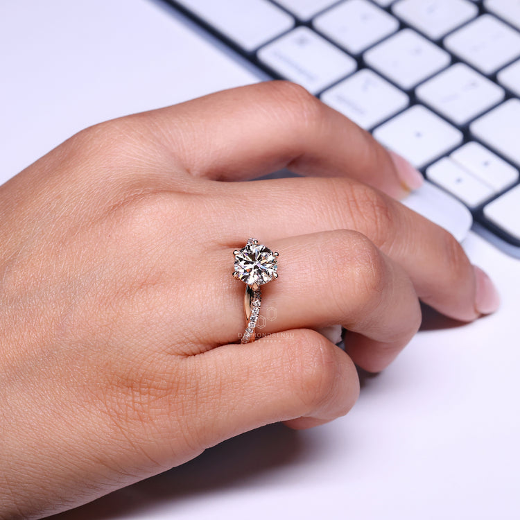 Round cut ring twisted pave six claw prong setting.