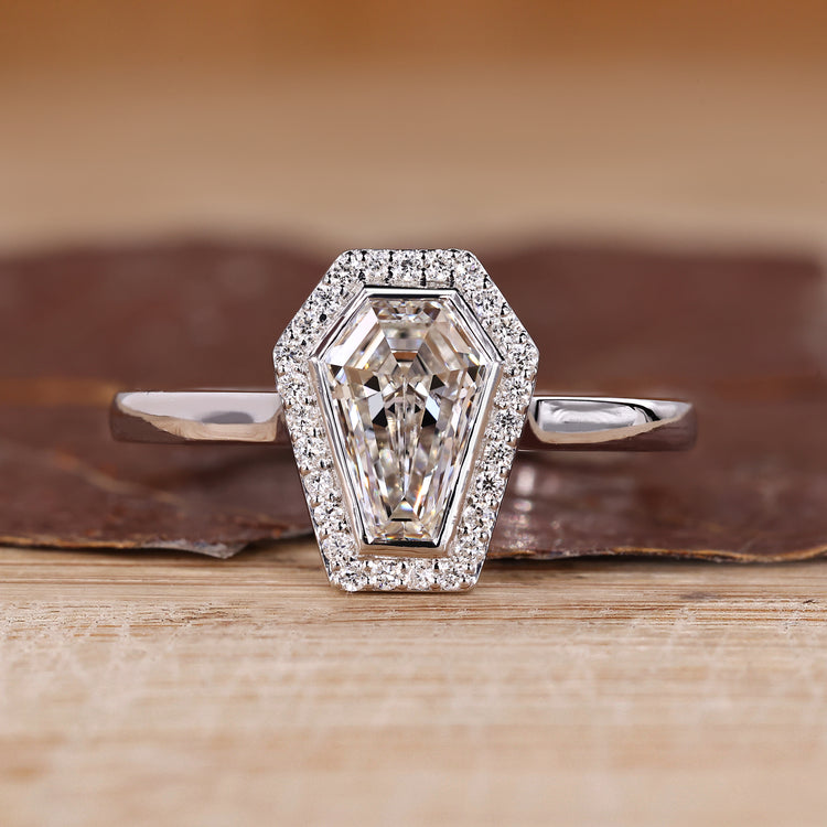 Coffin cut diamond ring halo bezel setting style.