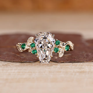 Coffin cut diamond ring green emerald side stones.