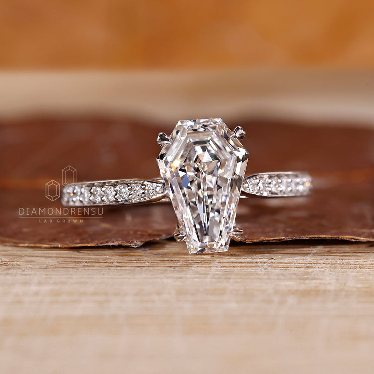 Pave band coffin diamond ring cathedral pinch shank.
