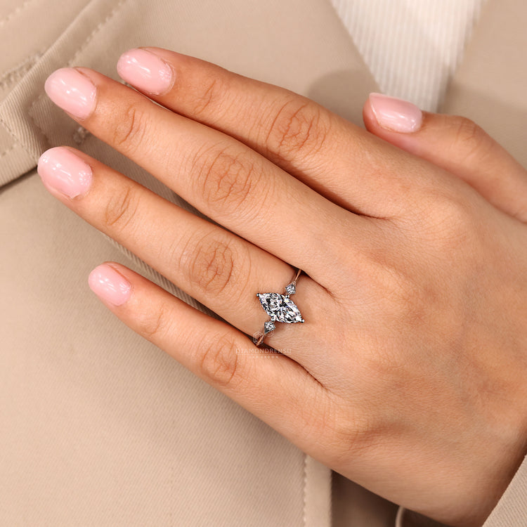Marquise diamond ring round side stones prong set.
