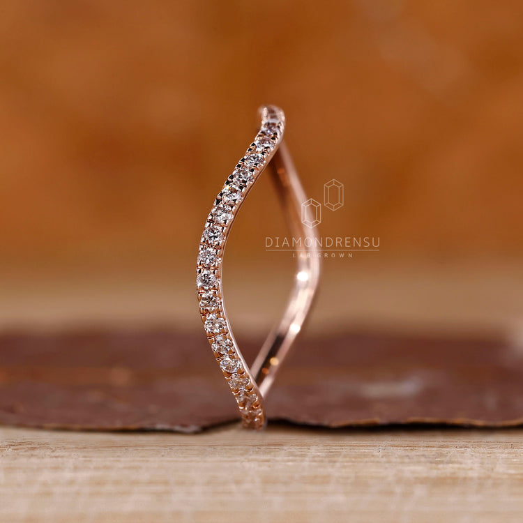 Round cut diamond band half eternity ocean wave style.
