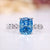 Cushion cut diamond ring with blue sapphire accent.
