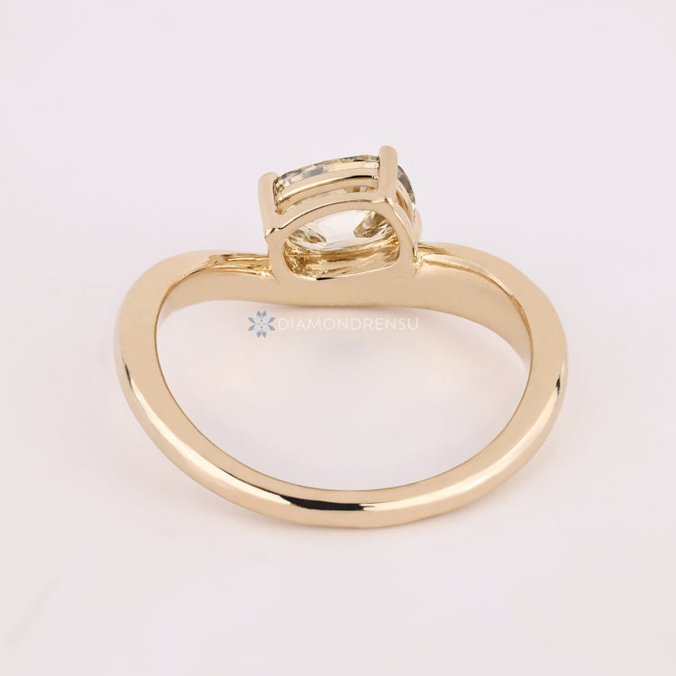 Handmade cushion diamond ring with east to west setting.