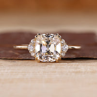Cushion Old European Cut Ring with round cut side stones.
