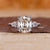 Cushion Old European Cut Ring with two pear side stones.
