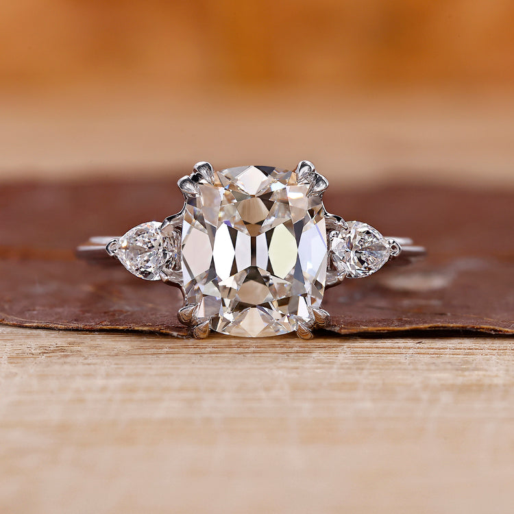Cushion Old European Cut Ring with two pear side stones.
