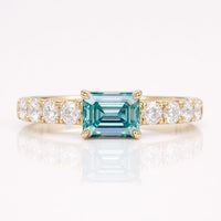 0.82 TCW Cyan Blue Emerald Moissanite Pavé Set East To West Ring