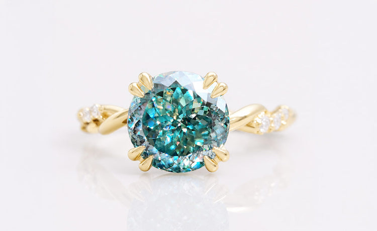 Antique cut coloured moissanite ring with a tinted centre stone in solid gold