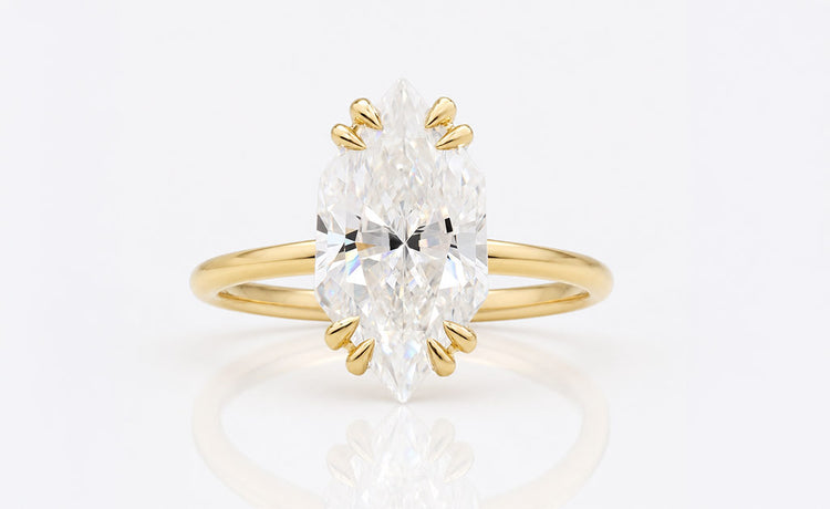 Antique cut moissanite solitaire ring on a plain solid gold band