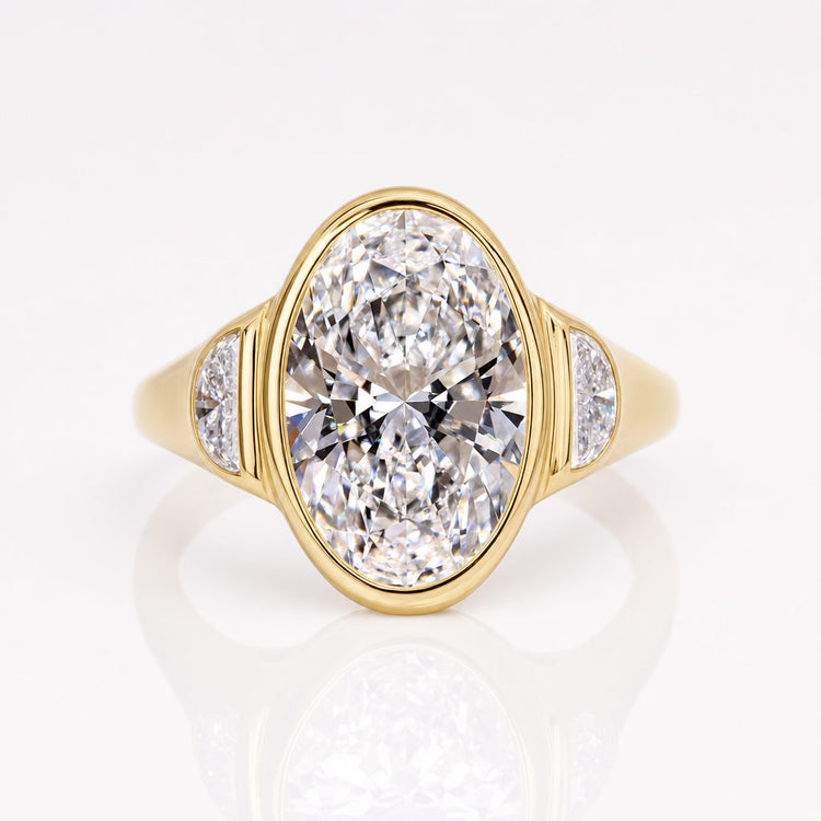 Bezel set oval engagement ring with a smooth metal rim framing the stone
