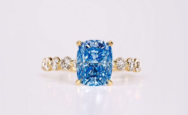 Cushion cut coloured lab grown diamond ring with a tinted centre stone