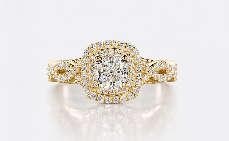 Cushion cut lab grown diamond halo ring framed by pave set diamonds