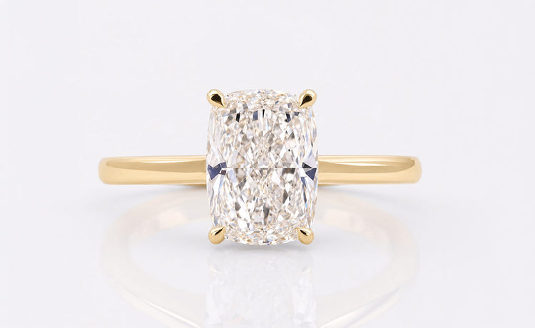 Cushion cut lab grown diamond solitaire ring on a plain solid gold band