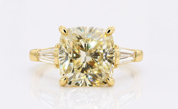 Cushion cut moissanite three stone ring with a centre stone and two side stones