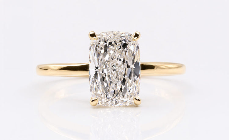 Cushion cut engagement ring with a soft square centre stone in a gold setting