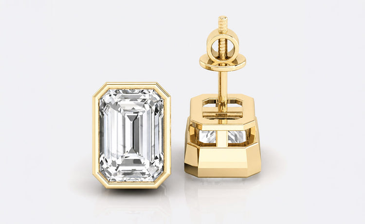 Emerald step cut moissanite stud earrings in bezel set solid gold