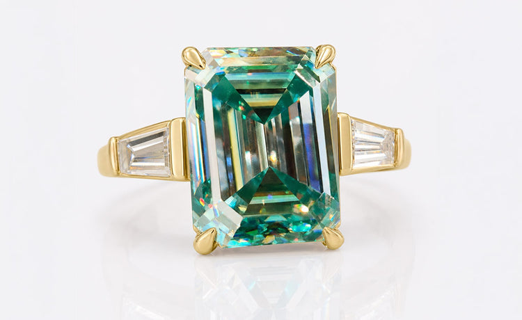 Emerald cut moissanite three stone ring with a centre stone and two side stones