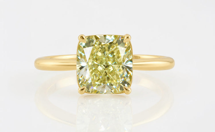 Greenish yellow moissanite stone with a warm canary tone