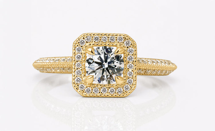 Halo engagement ring with a brilliant cut centre stone framed by pave set diamonds